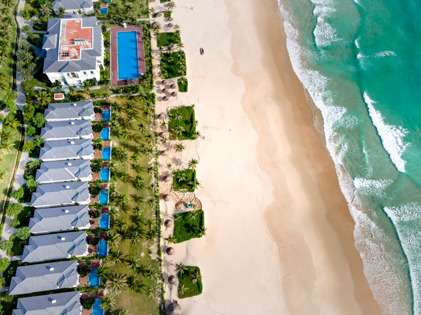 Stunning aerial beach resort view featuring turquoise waters and sandy shores, perfect for tropical getaways.