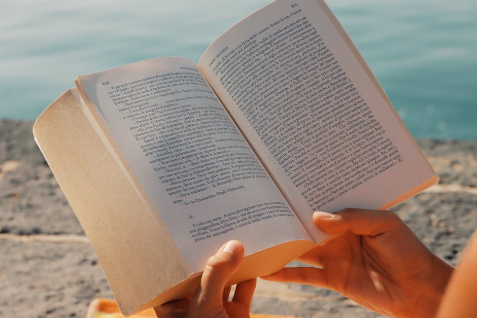 A person enjoys reading a book by the seaside in Syracuse, Sicily.