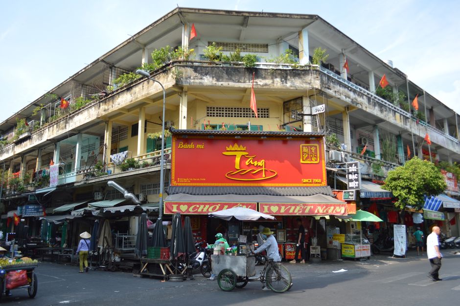 Busy street market in Hanoi, Vietnam showcasing local architecture and vibrant outdoor scene.