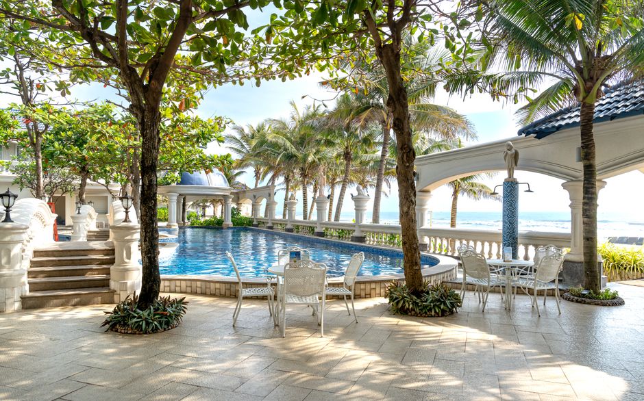 Stunning tropical resort with a luxurious poolside setting, perfect for a summer vacation.