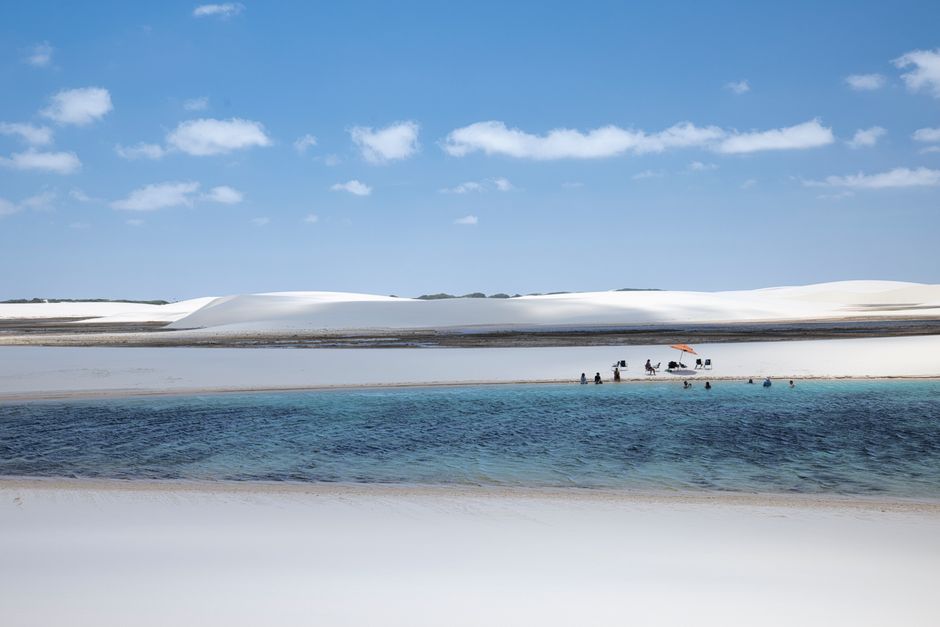 A tranquil lagoon amidst the white sand dunes of Lençóis Maranhenses in Brazil.