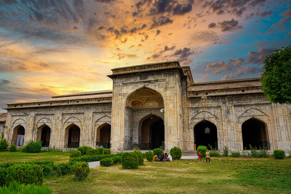 A stunning view of Pather Masjid in Srinagar, Kashmir at sunset showcasing Islamic architecture.