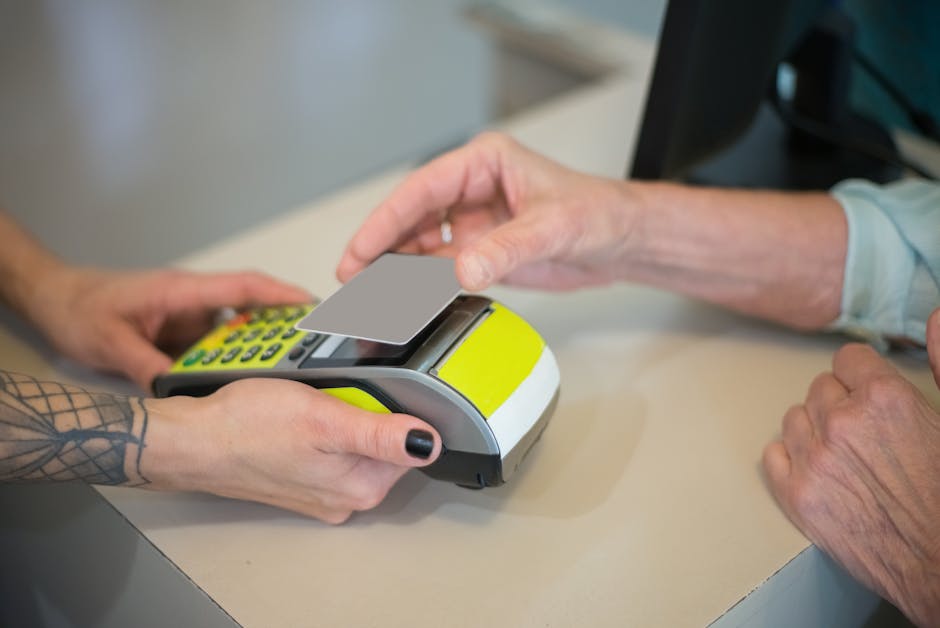 Hands using contactless payment on a POS terminal, highlighting cashless transactions.
