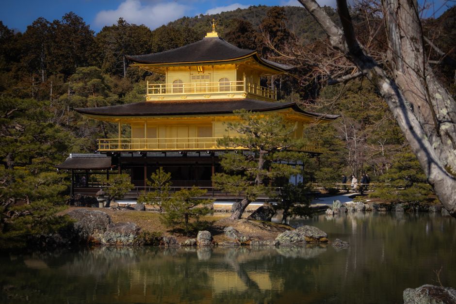 Beautiful view of Kinkaku-ji Temple reflecting in a serene pond in Kyoto, Japan.