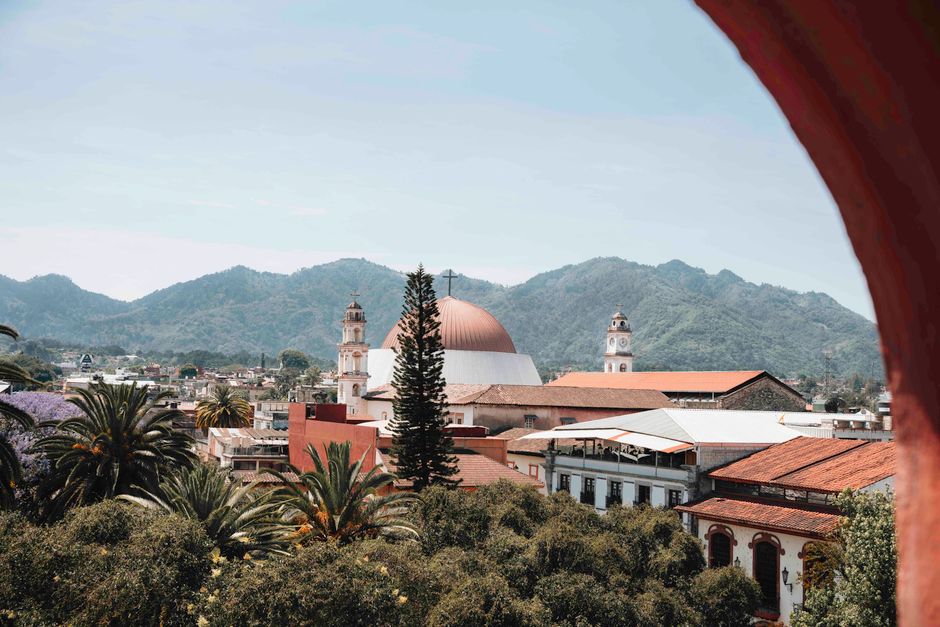 Stunning view of Huauchinango, Mexico, featuring a church and mountainous backdrop.