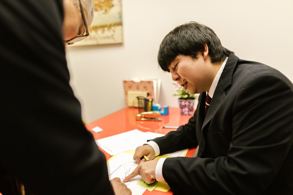 Businessman in a suit working on documents at the office desk.