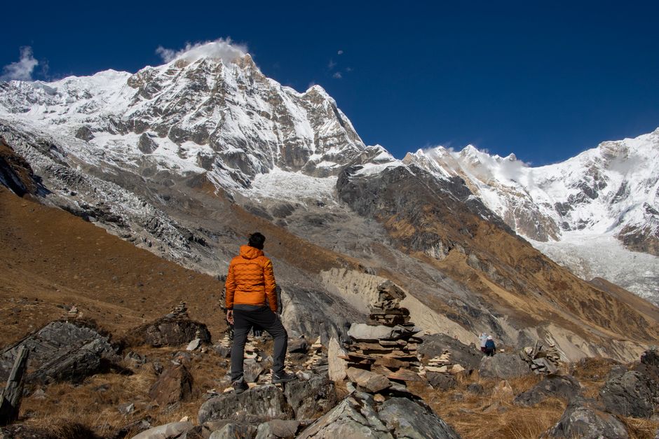 A trekker stands in awe of the majestic Annapurna mountain range in Nepal.