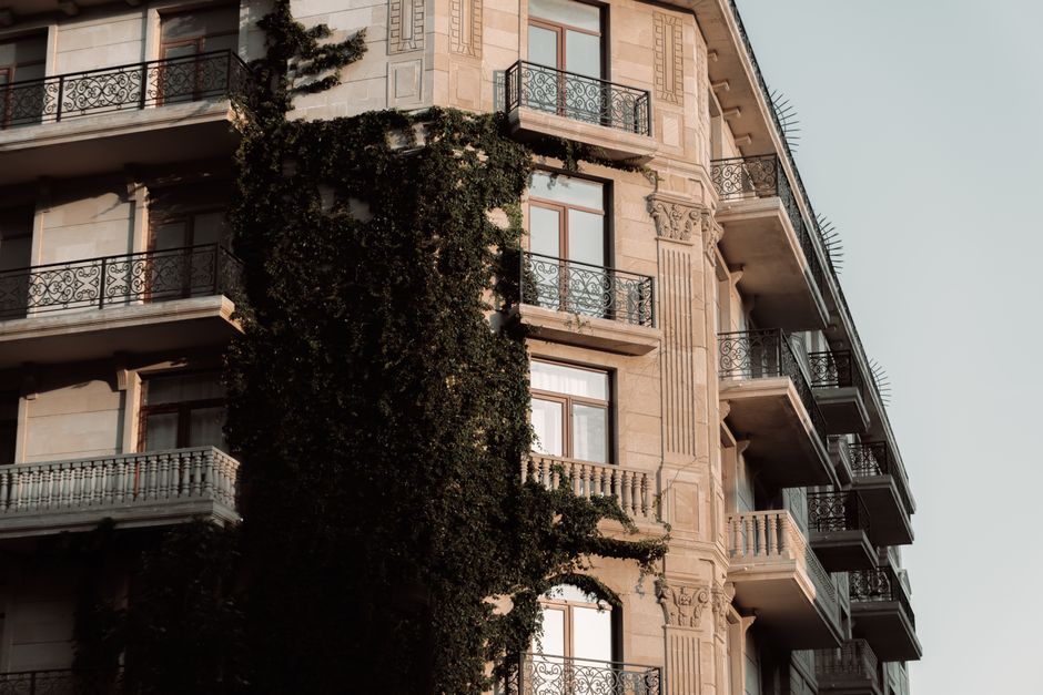 Stunning view of an ivy-covered historic building in Baku, Azerbaijan during sunset, capturing architectural elegance.