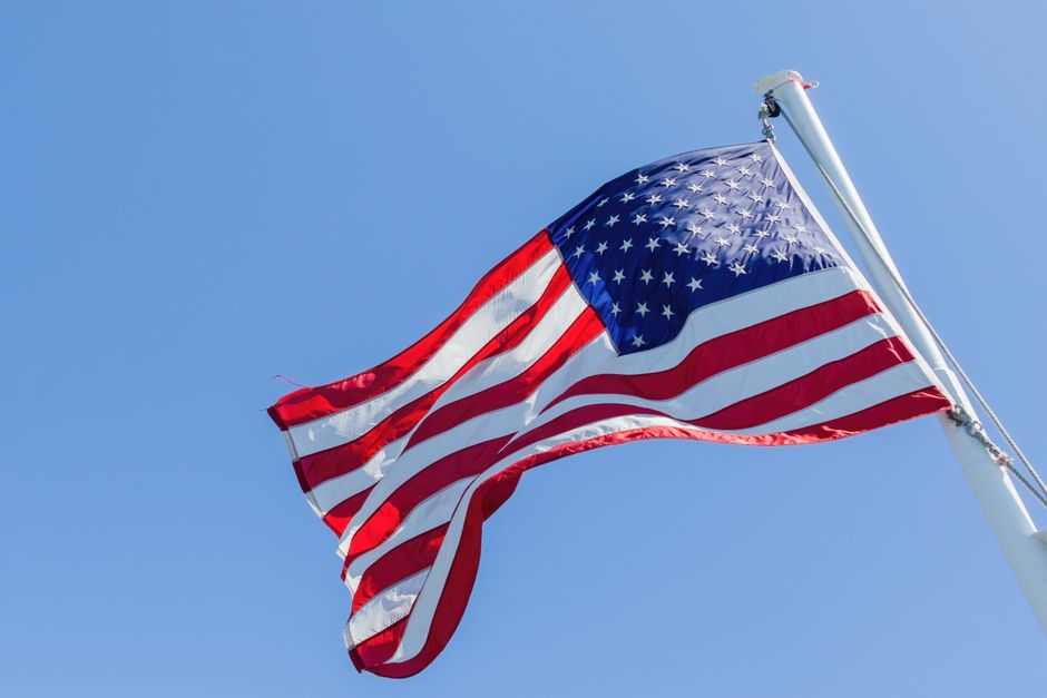 Vibrant image of the American flag waving on a clear day, symbolizing freedom and patriotism.