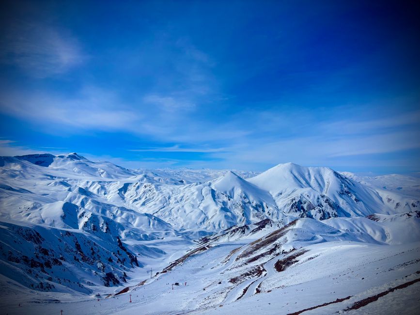 A breathtaking view of snowy mountains under a clear blue sky, evoking winter serenity.