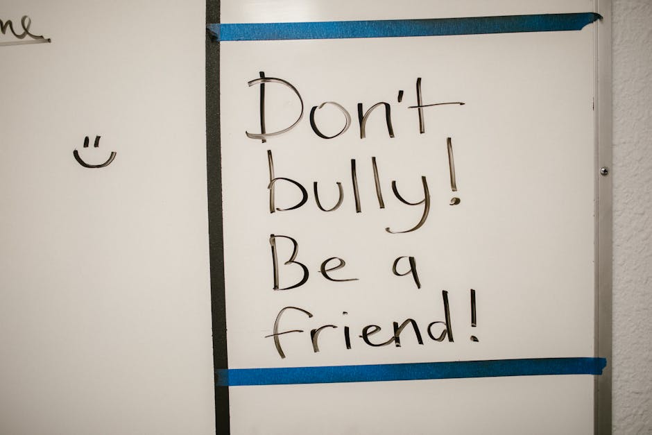 Message against bullying written on a whiteboard, promoting friendship.