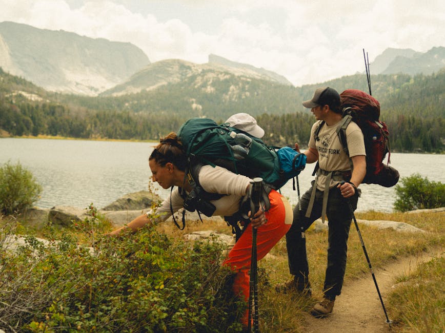 Two hikers trekking through the scenic landscapes of Wind River Range, Wyoming.