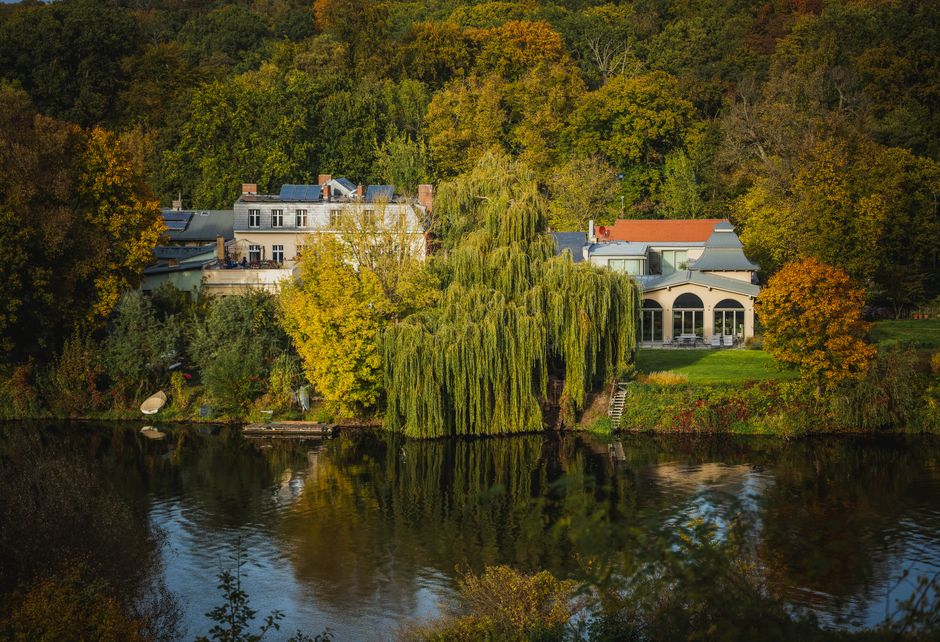 A peaceful autumn view of a tranquil lakeside setting in Potsdam, Brandenburg, Germany.
