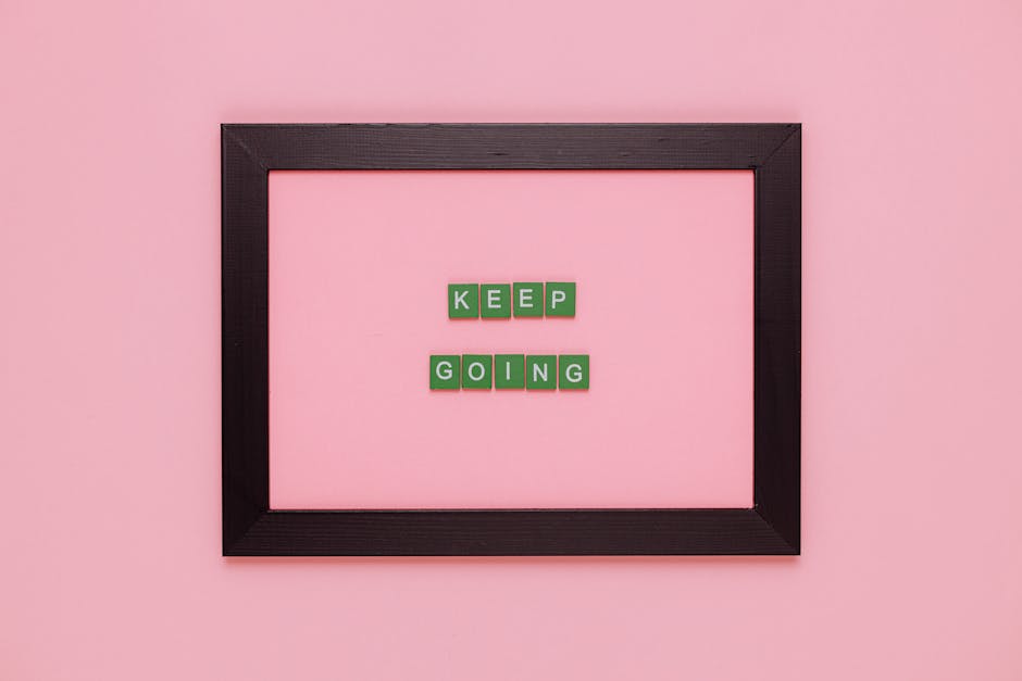 A framed motivational quote on a pink background for inspiration.